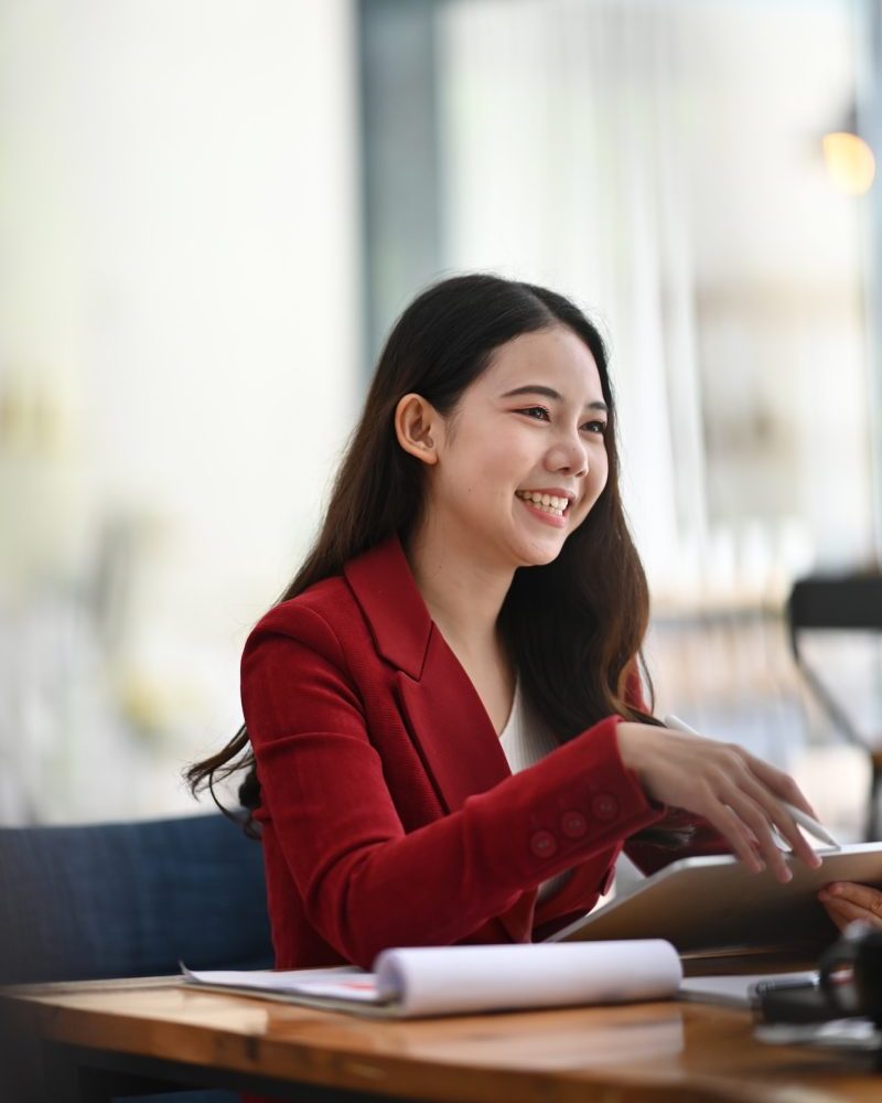 Cheerful businesswoman sitting in modern office.